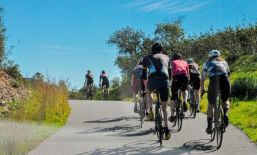 Cyclists climbing scenic Algarve hills