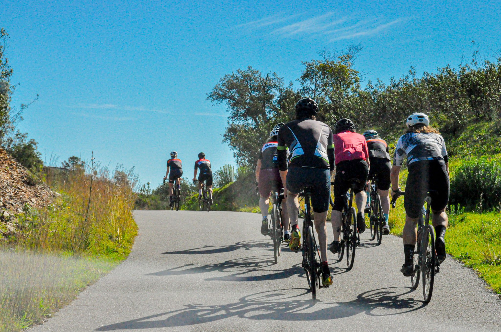 Cyclists climbing scenic Algarve hills