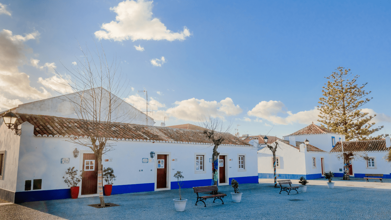 Whitewashed houses with trees in square