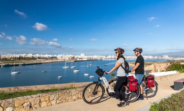 Cyclists enjoying the EuroVelo 1 bike tour with panoramic views of Lagos Algarve